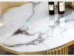 Modern oval marble dining table with gold stainless steel legs seating 6-8 people - Goldoma