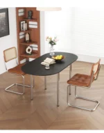 Nordic minimalist folding dining table with stainless steel telescopic extension in a modern living room setting