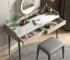 Modern makeup table with stone desktop and mirror in a bright bedroom