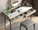 Modern makeup table with stone desktop and mirror in a bright bedroom