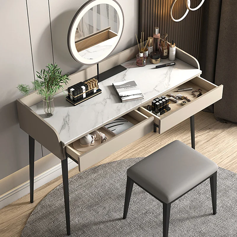 Modern makeup table with stone desktop and mirror in a bright bedroom