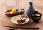 Japanese style ramen bowl set with melamine bowls, spoons, and noodle cups on a table