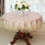 Elegant lace tablecloth with rose gold embroidery on a dining table