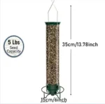 Hanging squirrel proof bird feeder in garden with a chickadee feeding