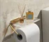 Aluminum alloy toilet paper holder with acrylic tray mounted on a white bathroom wall, side angle view.