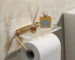 Aluminum alloy toilet paper holder with acrylic tray mounted on a white bathroom wall, side angle view.