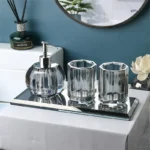 Bathroom set including soap dispenser and toothbrush cup on tray.