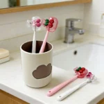Cherry Design Toothbrush Holder in white ceramic with cute cherry pattern, front view.