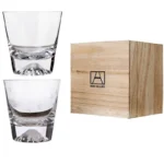 Transparent snow mountain whiskey glasses with Mount Fuji shape on a wooden table