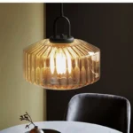 Modern colored glass pendant lamp illuminating a cozy dining room with vibrant hues