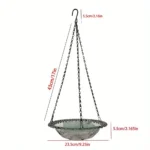 Bird bath tray with a shallow blue bowl, suspended from a wrought iron hook in a backyard.