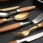 4-piece stainless steel flatware set with sapele wooden handles on a table