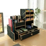 Desk accessories organizer in a living room setting, on a wooden desk with a lamp.