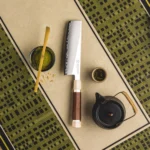 Professional nakiri knife with PM204 steel core and Mkuruti wood handle on wooden cutting board