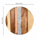 Round acacia cutting board with resin inlay on kitchen counter