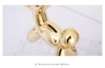 Balloon dog figurine on a white windowsill with a city view outside.
