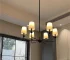 Modern kitchen island chandelier hanging over a kitchen island with warm LED light
