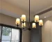 Modern kitchen island chandelier hanging over a kitchen island with warm LED light