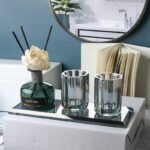 Bathroom accessories set in clear glass, modern style.