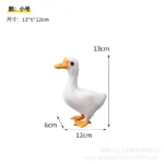 White goose decor on a patio table next to a potted plant, suggesting outdoor living use.