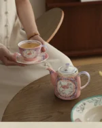 Elegant porcelain cups and saucers set on a wooden table