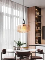 Modern colored glass pendant lamp illuminating a cozy dining room with vibrant hues
