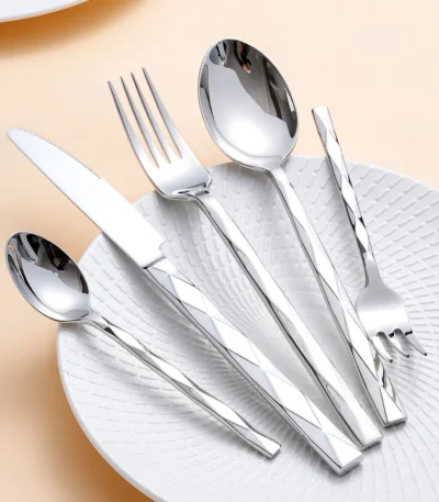Luxury stainless steel flatware set with diamond 3D texture on a wooden table