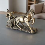 Close-up of the golden horse's head with detailed mane and bridle, highlighting metallic finish.