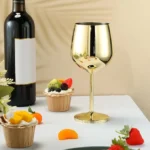 Set of 6 stainless steel wine glasses on a wooden table with red wine