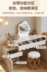 Modern makeup vanity desk with mirror and stool in a bedroom setting, showcasing ample storage and elegant design