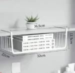 Metal under shelf basket hanging from a kitchen shelf, holding spices and small jars