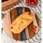 Round acacia cutting board with resin inlay on kitchen counter