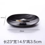 Black melamine dinner plates stacked elegantly on a wooden table