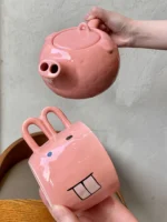 Funny pig teapot pouring tea from its snout on a kitchen counter