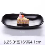 Black melamine dinner plates stacked elegantly on a wooden table