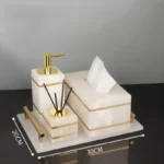 Soap dish and toothbrush holder set on marble tray.