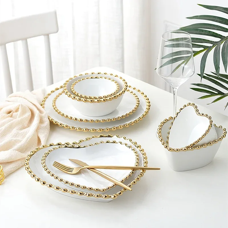 White ceramic salad bowl with heart-shaped design on a wooden table