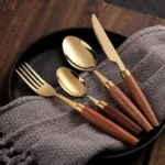 4-piece stainless steel flatware set with sapele wooden handles on a table
