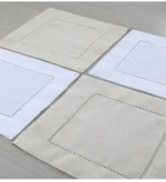White linen cloth napkins hemstitched cocktail napkins set of 100 on wooden table