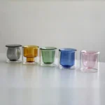Clear double wall insulated glass mug with espresso coffee on wooden table