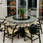 Elegant lace tablecloth with rose gold embroidery on a dining table