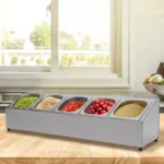 Stainless steel spice rack with 5 pans and lids on kitchen countertop