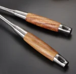 7-piece stainless steel cookware set with rosewood handles arranged on a kitchen counter