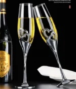 Elegant crystal champagne glasses set on a table with sparkling wine