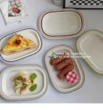 Handcrafted ceramic plates with underglaze floral design on a wooden table