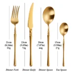 Matte gold flatware set with antique finish arranged on a wooden table