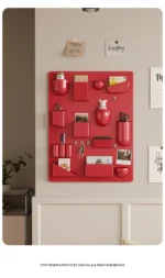 White desk organizer shelf with books and office supplies on a wooden desk