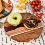 Round acacia cutting board with resin inlay on kitchen counter