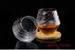 Set of hazy wine glasses with hammer pattern and snowflake design on a wooden table