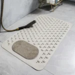 Oblong non-slip bath mat with suction cups on shower floor